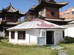 Low, round white building with a conical roof