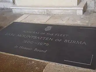 Black stone marker set into a flagstone floor. Engraved words read "Admiral of the fleet. Earl Mountbatten of Burma. 1900–1970. In Honour Bound"