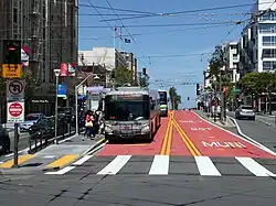 A bus stop with bus in the median of an urban arterial