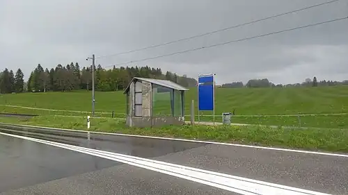 Covered shelter on side platform next to roadway