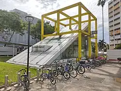 Photograph of station entrance encased in a yellow cubic structure
