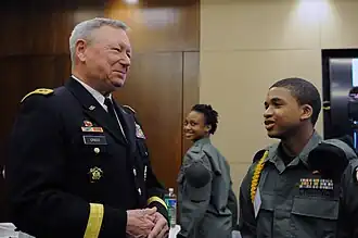 Army Gen. Frank Grass, chief, National Guard Bureau, converses with a Capital Guardian Youth ChalleNGe Academy cadet.