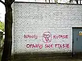 Anti-phallic graffiti, reading Nawój kutasie opanuj swe ptasie, sprayed onto a wall in Poznań, Poland