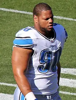 Ndamukong Suh in a Detroit Lions jersey with no helmet, from the waist up.