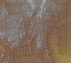 A map of a state's terrain, with brown and white colors representing higher elevations, and yellow and green colors representing lower elevations. County borders are also shown on the map.