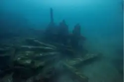 The wreckage of a submerged ship, featuring one of its paddle wheels