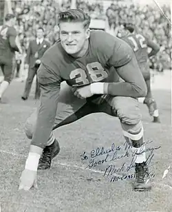 Signed black and white photo of Susoeff in a football stance on a field