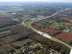 Aerial view of a divided highway and several ramps that lead into a toll plaza