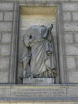 Saint Luke. The statue lost its head to a German shell in World War I.