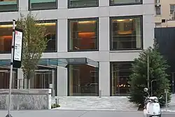 The porte-cochère on 56th Street, as seen from across the street. It consists of a small driveway looping in front of the main entrance; there is a canopy over the entrance.