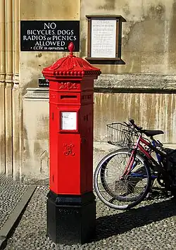 A Victorian hexagonal red post box of the Penfold type manufactured in 1866 outside King's College, Cambridge (not the original location for this box)