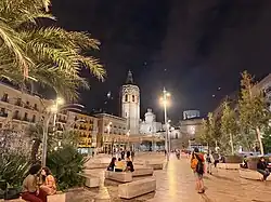 plaza night scene with awnings stretched across tall poles
