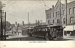 Postcard view of two streetcars in an urban area