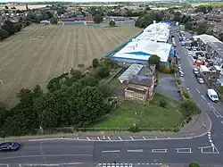 A view of an old abandoned train station, overgrown - shot with a drone.