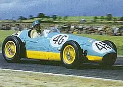 Bira driving his 1954 Maserati 250F in the 1954 French Grand Prix. The adaptations to the official racing scheme needed for post-WWII cars that lacked visible chassis rails are clearly seen: the yellow now forms a broad band around the lower part of the car's bodywork