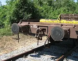 Buffers and chain coupler on goods wagon. The chain hangs on the towing hook.