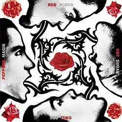 The four band members' faces with elongated tongues that wrap around a rose.