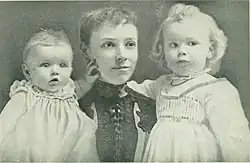 Helen Taft as a young woman holds a small child in each arm