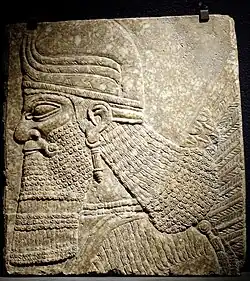 Winged genius head relief from the palace of Ashurnasirpal II, Nimrud (Iraq), c. 883–859 BC