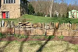 Sleeper stones from Inclined Plane 7 West used as the base of retaining wall