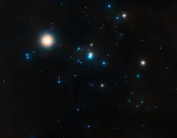 Hyades, with ρ Tau appearing blue, left of center, marked with a red arrow