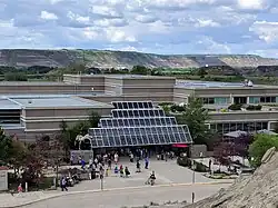 Photo of a museum building with a mountanous background