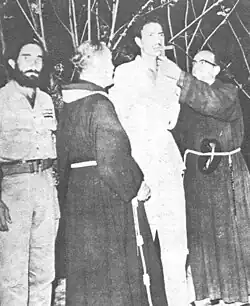 Priests from Manzanillo give last sacraments to Ramón Llópiz Reytor before his execution by firing squad (January 30, 1959).