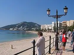 Seafront and beach with the hill 'Puig d’ en Fita' in the background.