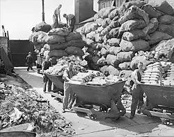 Bagged aluminium supplies piled up before carts of aluminium