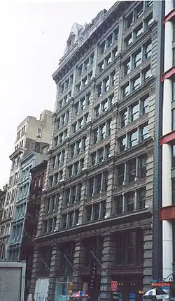 View of aging cast iron facade with deteriorated paint and corrosion conditions.