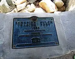 Scorpion Gulch historical marker which reads "Scorpion Gulch Trading Post 1936".