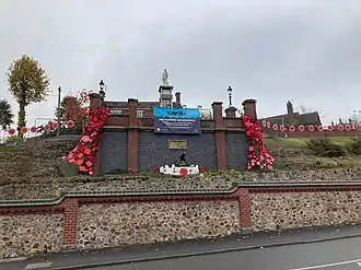 Memorial as described in body, with garlands of poppies on the retaining walls