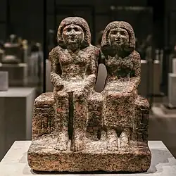 Seated portrait group of Dersenedj and his wife Nofretka; c. 2400 BC; rose granite; Egyptian Museum of Berlin