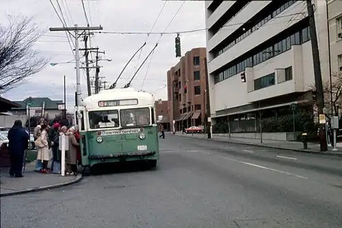 15th Ave. E. bus stop in Seattle, circa 1976, with a Group Health building (now Kaiser Permanente) at right