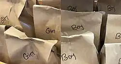 Opaque grab bags labeled "girls" and "boys"