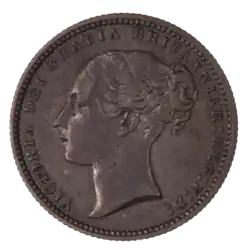 A British shilling, featuring Queen Victoria.