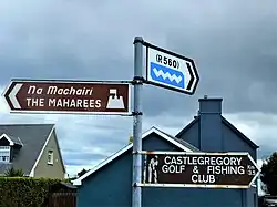 Fingerposts in Ireland with tourist attractions and road names.