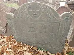 Slate Tombstone from 1740 with deaths head imagery, carved in Boston
