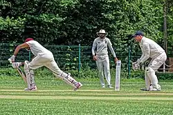 Cricket: wicket-keeper with baseball cap