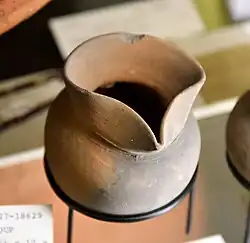 Spouted jar, brown smooth pottery. From a box containing infant burial, with a lock of hair, shell, slip of wood, and beads. 12th Dynasty. From Lahun (Kahun), Faiyum, Egypt. Petrie Museum, London