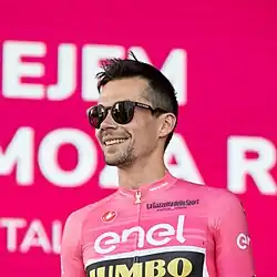 Primož Roglič wearing pink Giro d'Italia leader's jersey.