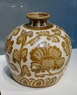 Unusual painted Ding ware bottle with iron pigment over transparent colourless glaze, 11th century