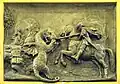 Close-up of the bronze relief featuring St. George and the dragon.