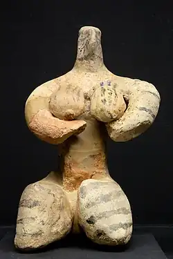 Seated birthing figurine from the Halaf period. Royal Museums of Art and History, Brussels.​​‌