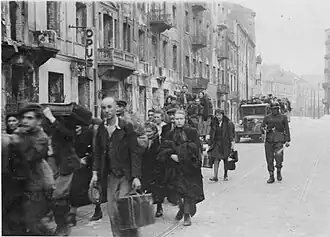 NARA copy #31 To the transhipping place Column heading North to Umschlagplatz on Zamenhofa Street near Kupiecka. In the back buildings of Zamenhofa 30-40 block.