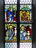 Stained glass window in the church depicting benefactors
