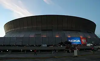 Domed stadium in shadow, ground view looking up