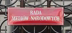 The National Media Council plaque on the tenement house at Aleje Ujazdowskie 26 in Warsaw