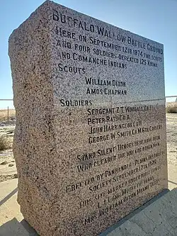 alt=A granite slab that reads "Buffalo Wallow Battle Ground Here on September 12th, 1874, Two Scouts and Four Soldiers Defeated 125 Kiowa and Comanche Indians. Scouts William Dixon Amos Chapman Soldiers Sergeant Z. T. Woodall.Co.I. Peter Rath.Co.A. John Harrington.Co.H. George W. Smith.Co.M.6th.Cavalry. Stand Silent Heroes Here Have Been, Who Cleared The Way For Other Men. Erected By Panhandle-Plains Historical Society, September 12, 1925. This Site Marked Under Direction of L.L. Long Mobeetie Texas Mrs. William Dixon Miami Texas"
