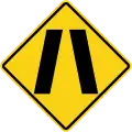 Road narrows on both sides
